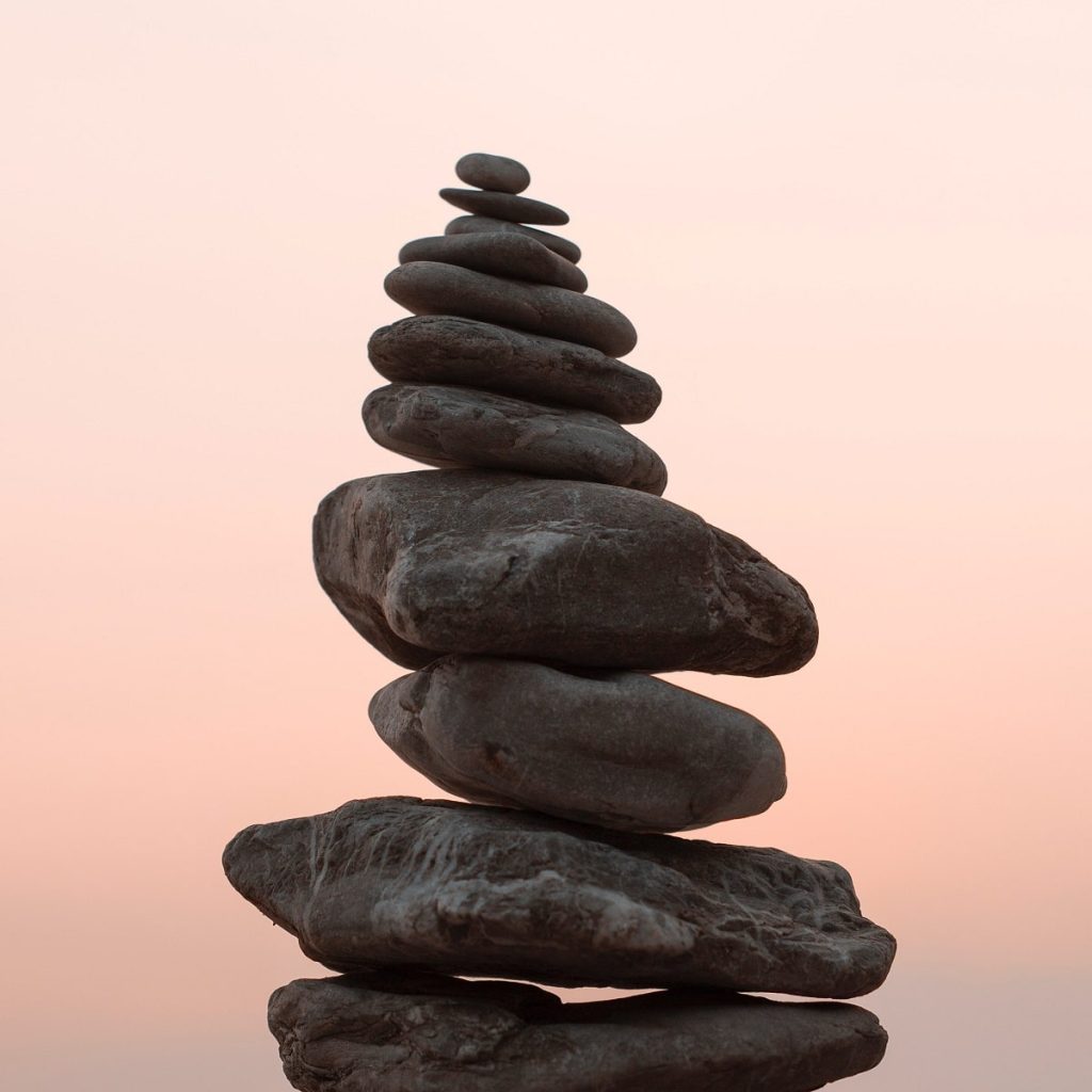 pebbles balanced, representing balance under gravity
